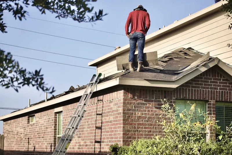 Professional roofer working on a residential roof in Point Lookout
